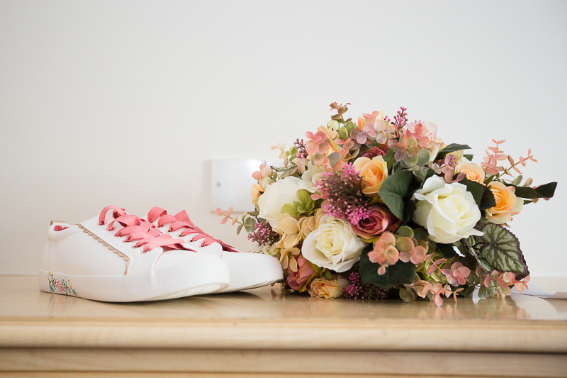 Brides wedding shoes and flowers at Burntwood Court Hotel Wedding