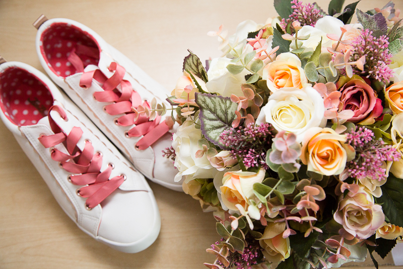 Brides wedding shoes and flowers at Burntwood Court Hotel Wedding