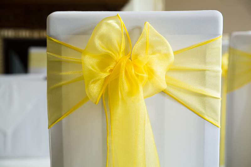 yellow bow on the back of a white chair cover at Wortley Hall Hotel Sheffield