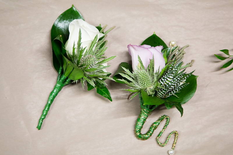 Buttonholes roses with green leaves