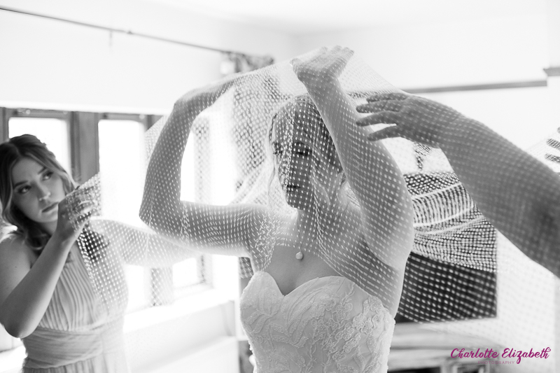 Bridal preparations putting on the wedding veil at home by Charlotte Elizabeth Photography Barnsley Photographers