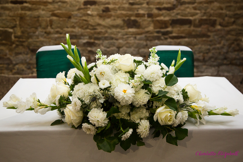White and green flowers in the ceremony room at Mosborough Hall Hotel Sheffield Wedding